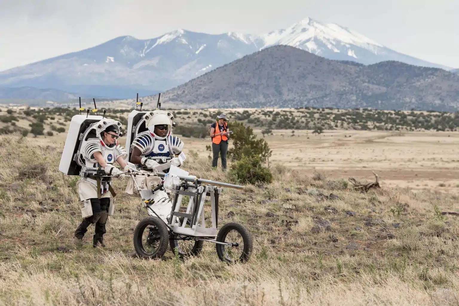 האסטרונאוטים קייט רובינס ואנדרה דגלס דוחפים עגלת כלים עמוסה בכלי ירח בשדה הוולקני סן פרנסיסקו צפונית לפלגסטאף, אריזונה, כשהם מתרגלים פעילויות של הליכות ירח למשימת ארטמיס 3.
קרדיט: Credit: NASA/Josh Valcarcel